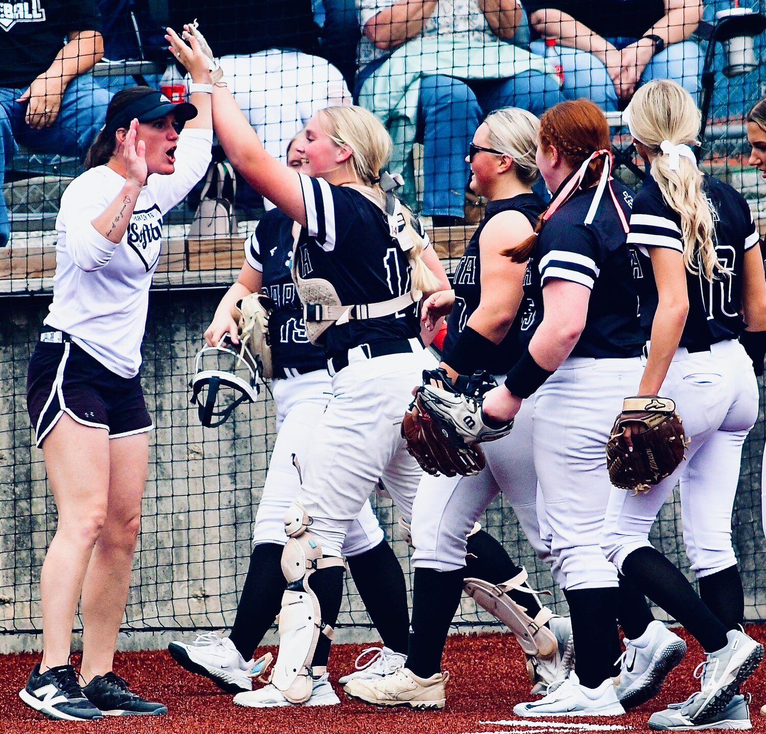 SPARTA'S MADELINE BROWN shares a winning high-five with coach Jamie Holmes.