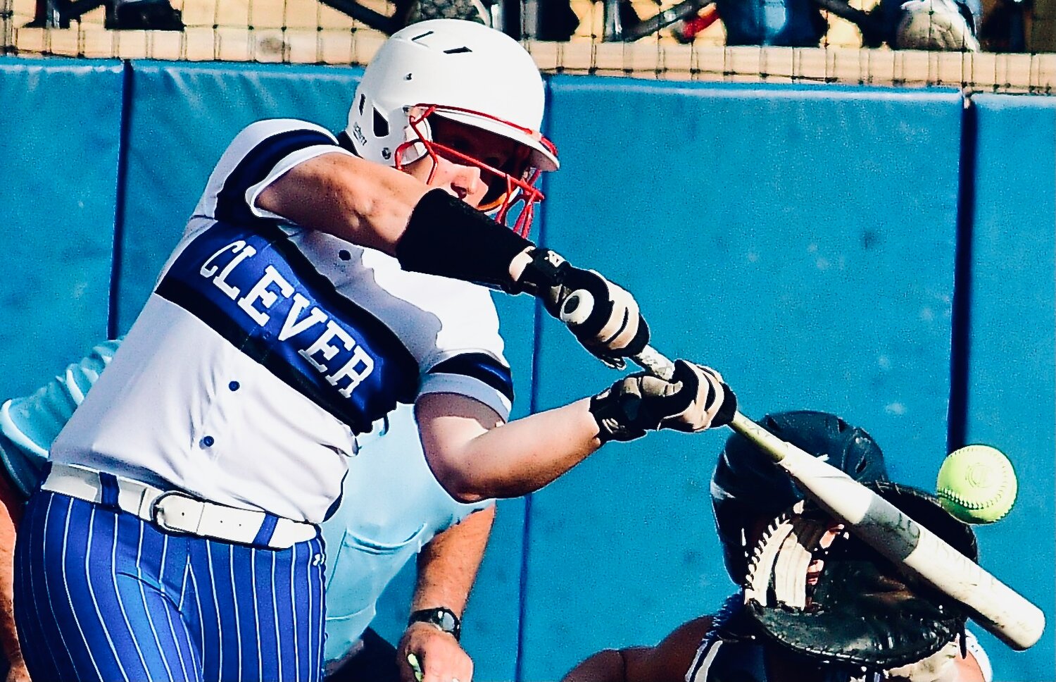 CLEVER'S KARLI HEDGE goes the opposite way with an outside pitch.