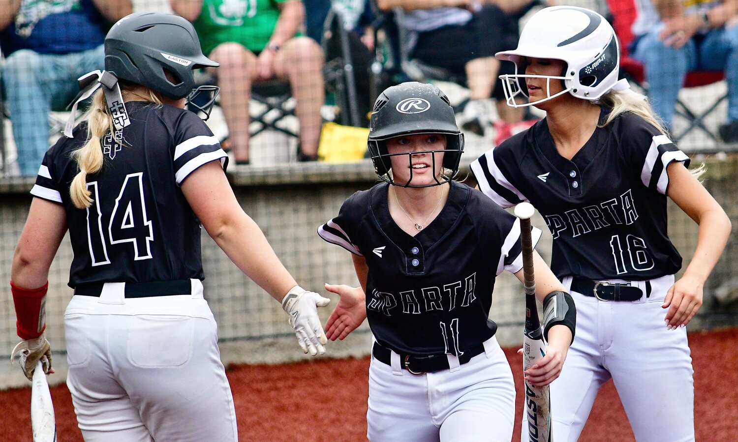 SPARTA'S MADELINE BROWN, LAYNE FORGEY AND AVERI LEYLAND celebrate two Lady Trojans runs.