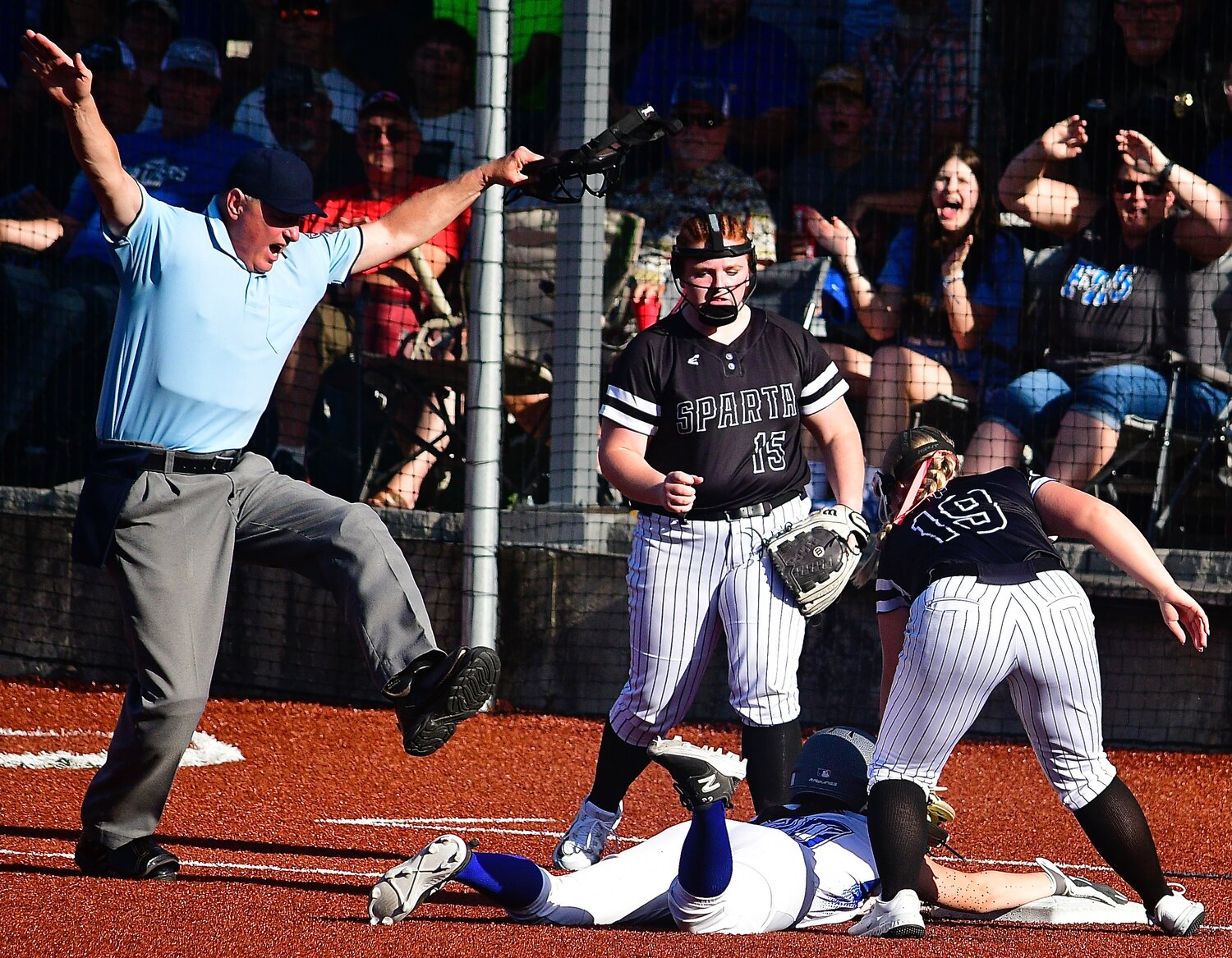 SPARTA'S ADDISON TAYLOR looks up for the umpire's safe call.