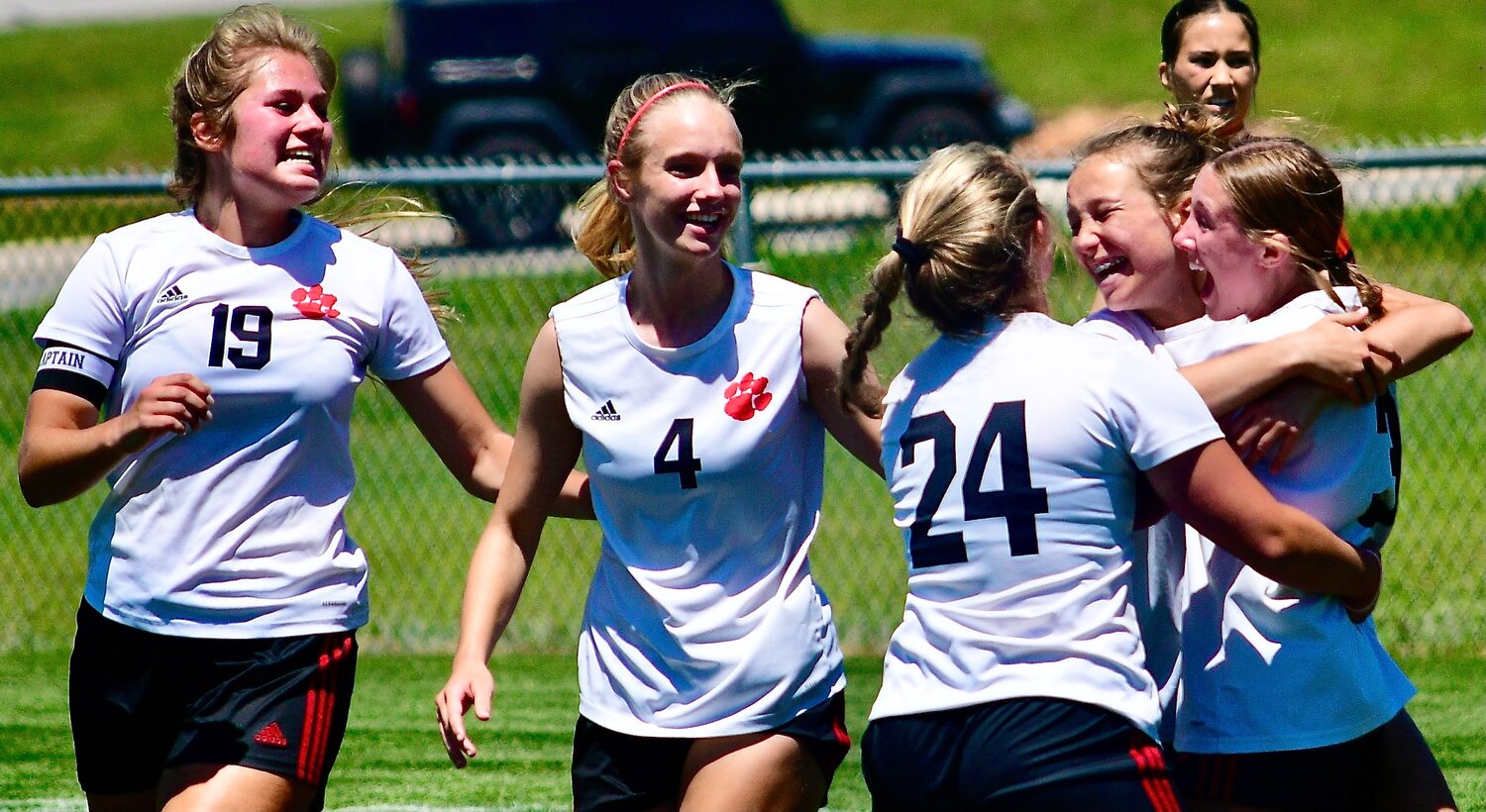 OZARK'S ANNABELLE KRUSE is all smiles while receiving congrats from teammates for a goal.