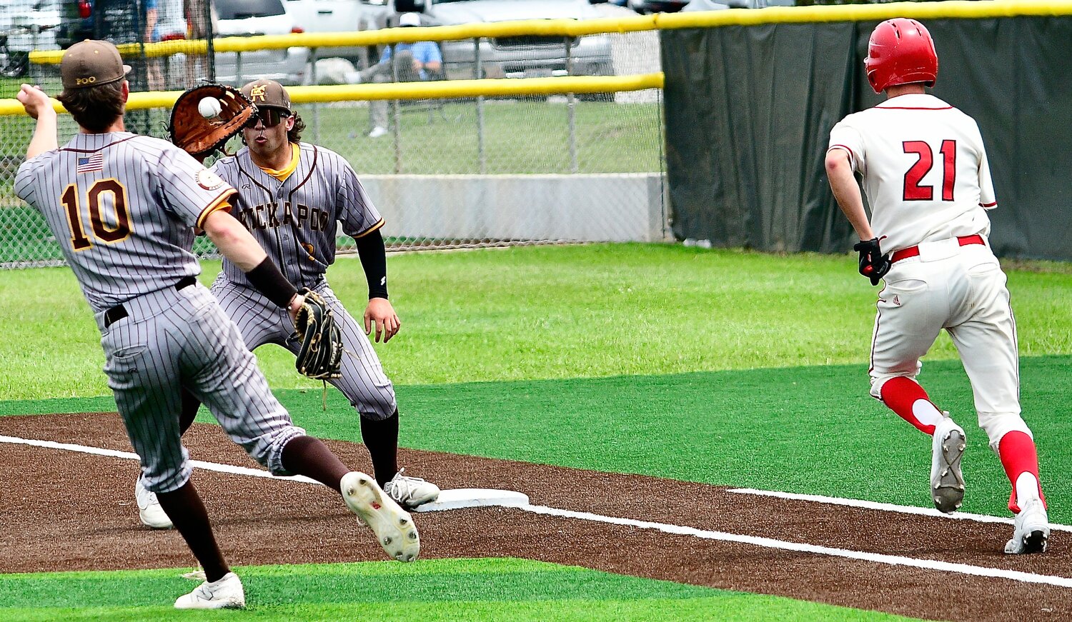 OZARK'S ALEX NIMMO races down the first-base line as Kickapoo retires him at first base.