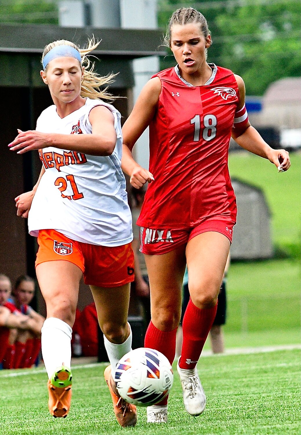 NIXA'S BROOKE TETER and a Republic player chase down the ball.