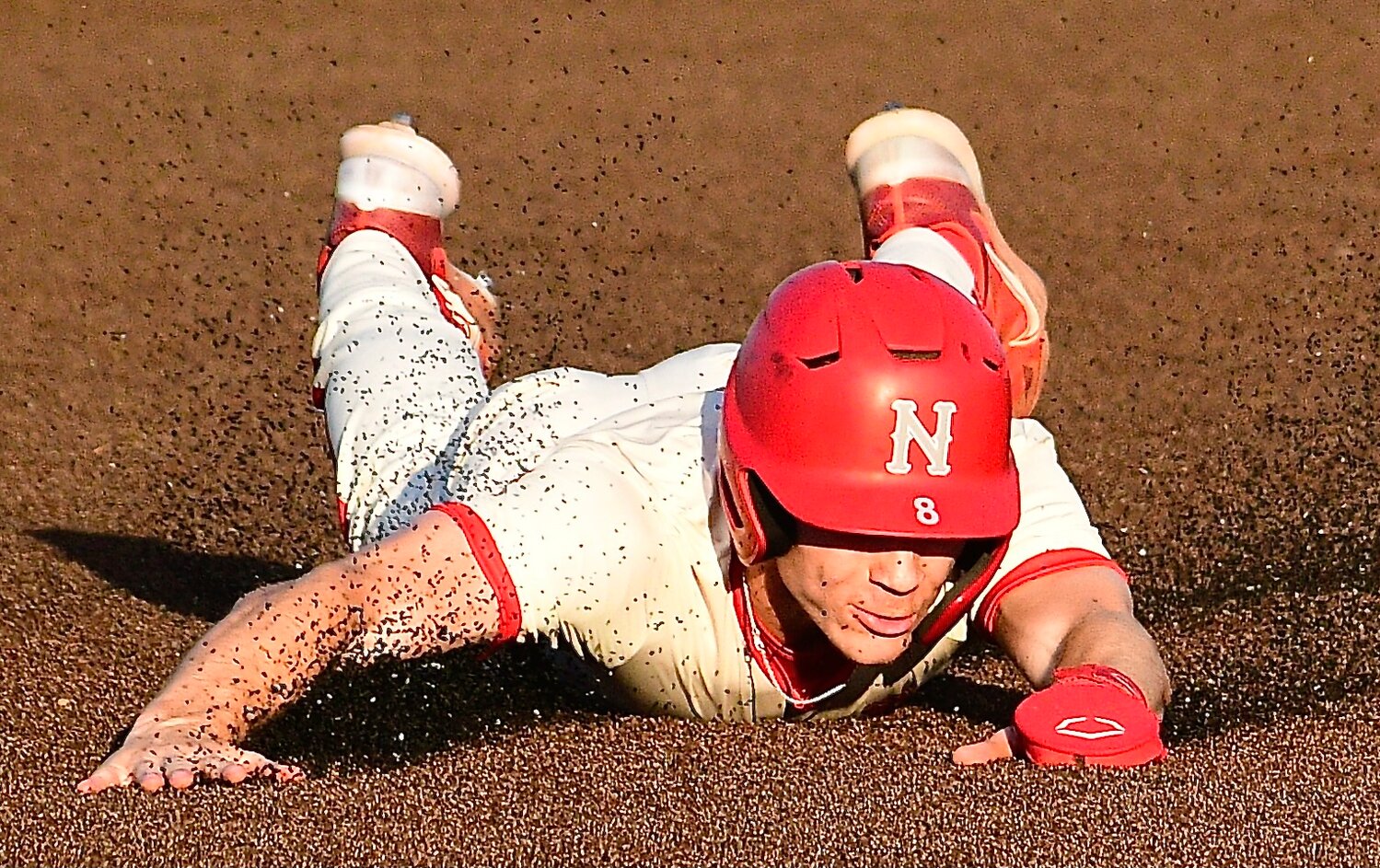 NIXA'S ADAM MCKNIGHT tumbles to the turf in between second base and third base.