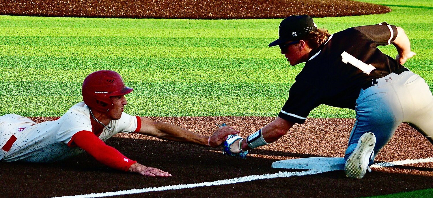 NIXA'S PARKER MANN is tagged out at third base.