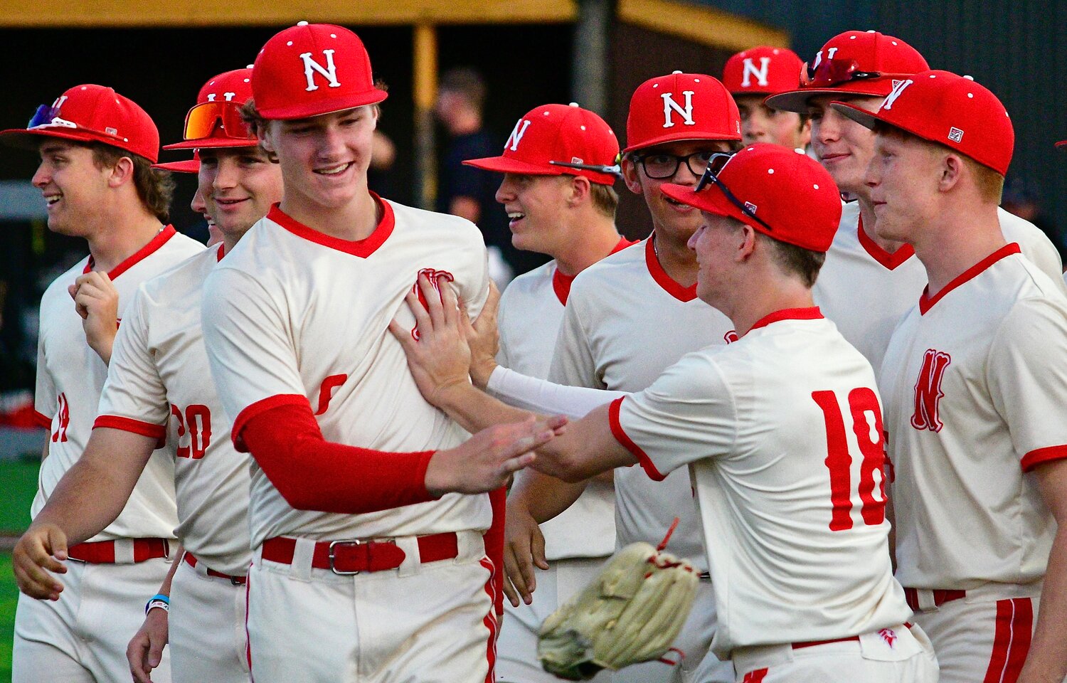 NIXA'S JACKSON GAMBLE is surrounded by teammates after the Eagles' win.