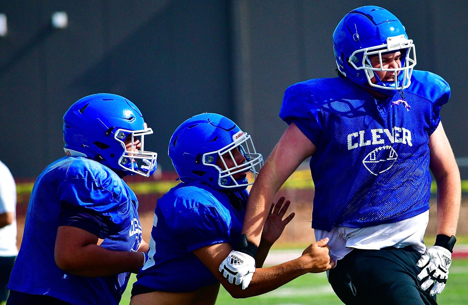 CLEVER OFFENSIVE LINEMEN (l-r) Isaiah Hutson, Nehemiah Johnson and Max Allie celebrate a Jays score at the Evangel Team Camp.