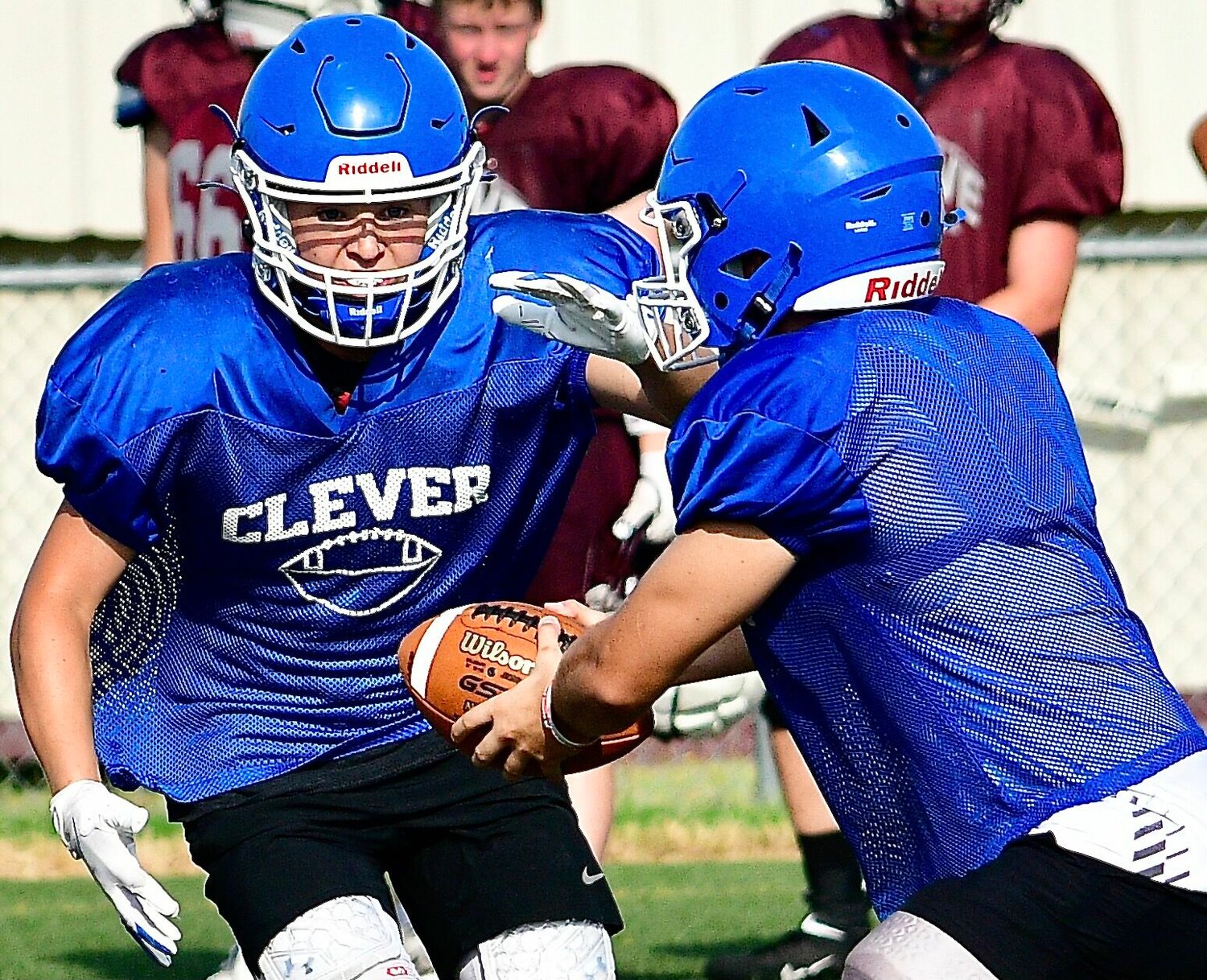 CLEVER'S TRENTON ALLEN, left, receives a handoff from quarterback Rex Deters.