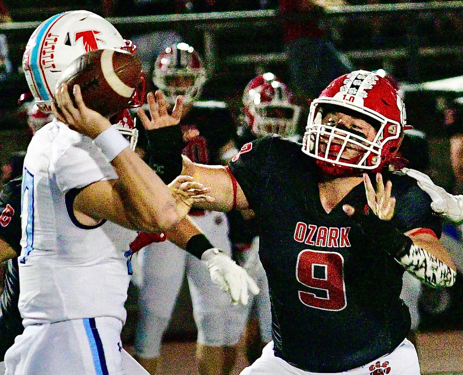 OZARK'S RUBEN ARVIZU applies pressure on Glendale quarterback Cash Newberry.