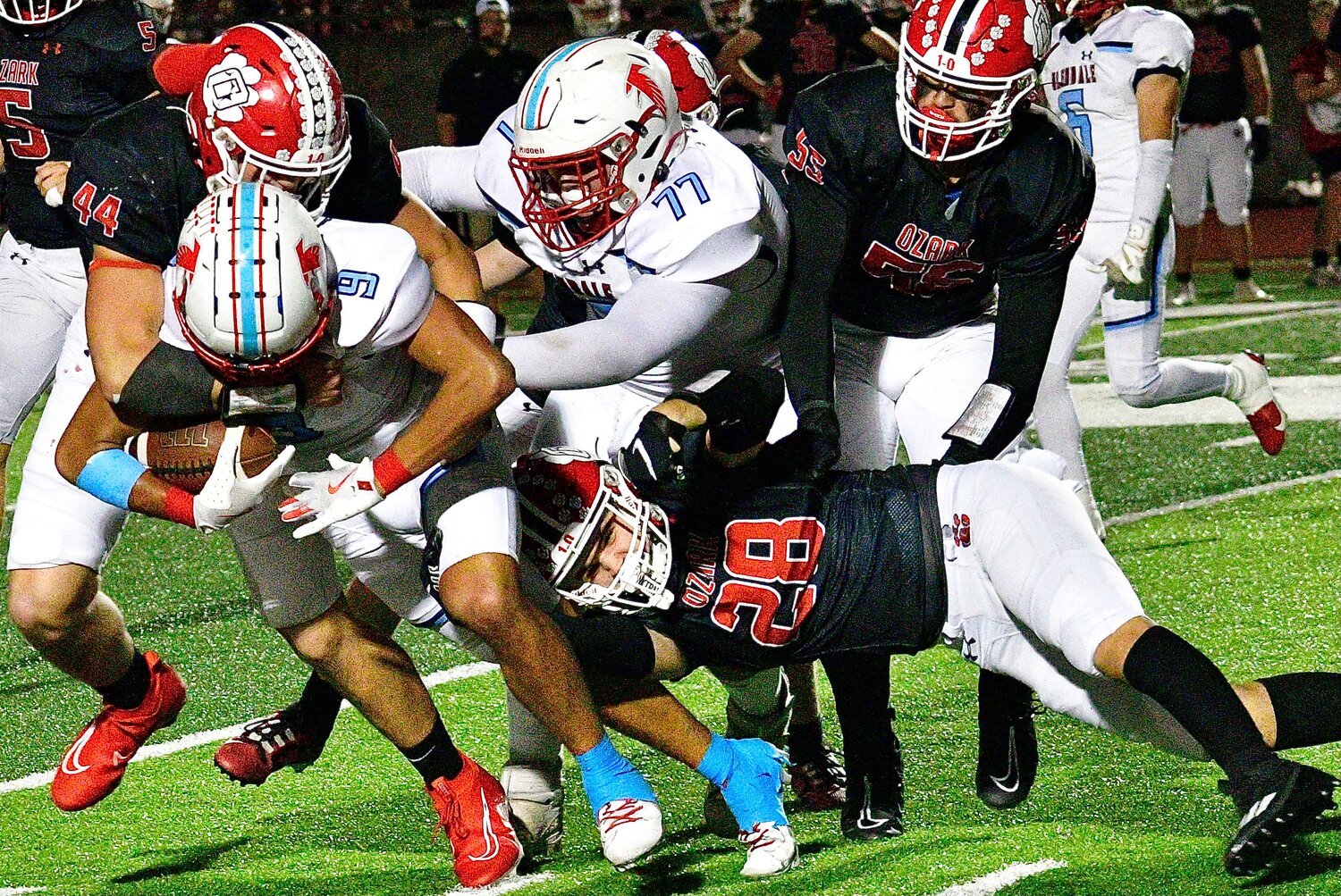 OZARK'S PARKER ELLIOTT AND ETHAN CHANDLER team for a tackle.