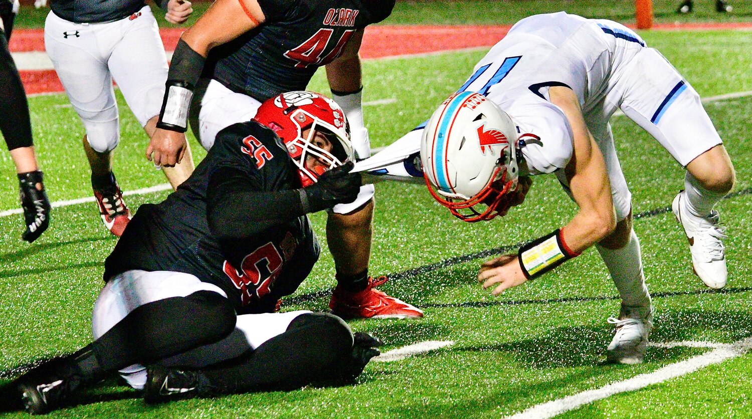 OZARK'S QUENTIN COMBS records a one-handed tackle.