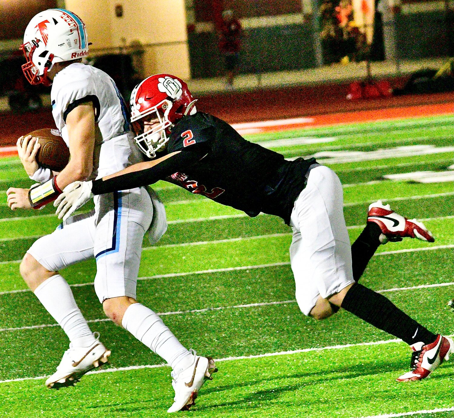 OZARK'S MARCUS HEAVIN makes a tackle.