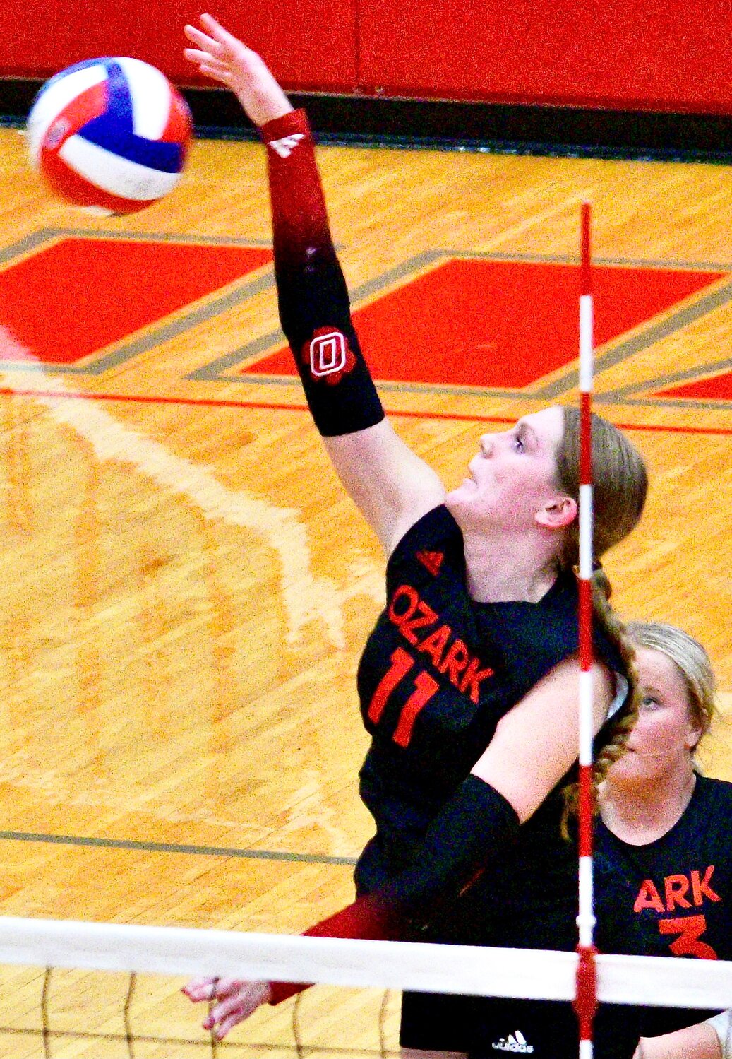 OZARK'S TARA VENABLE attacks at the net.