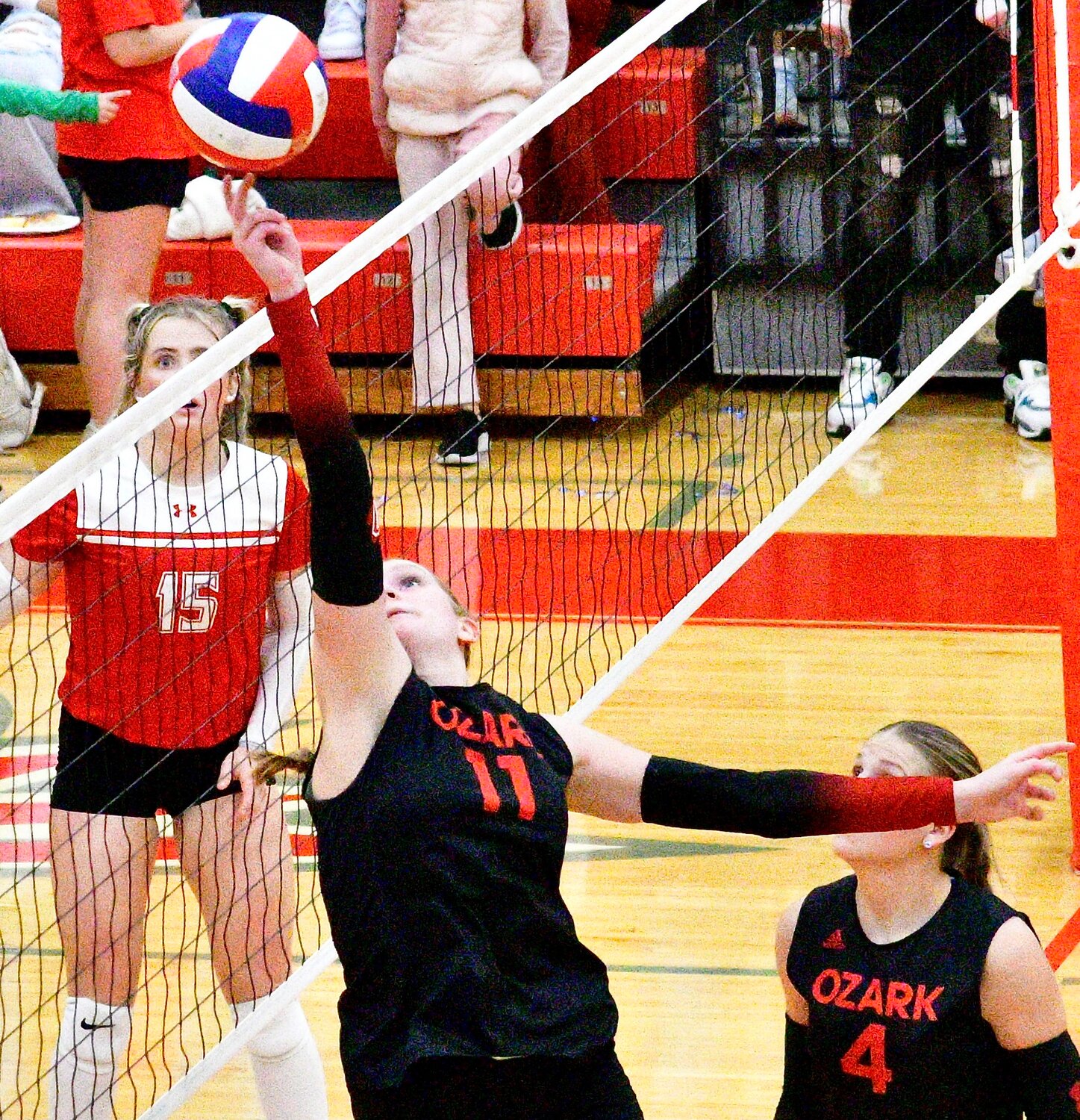 OZARK'S TARA VENABLE tips the ball over the net.