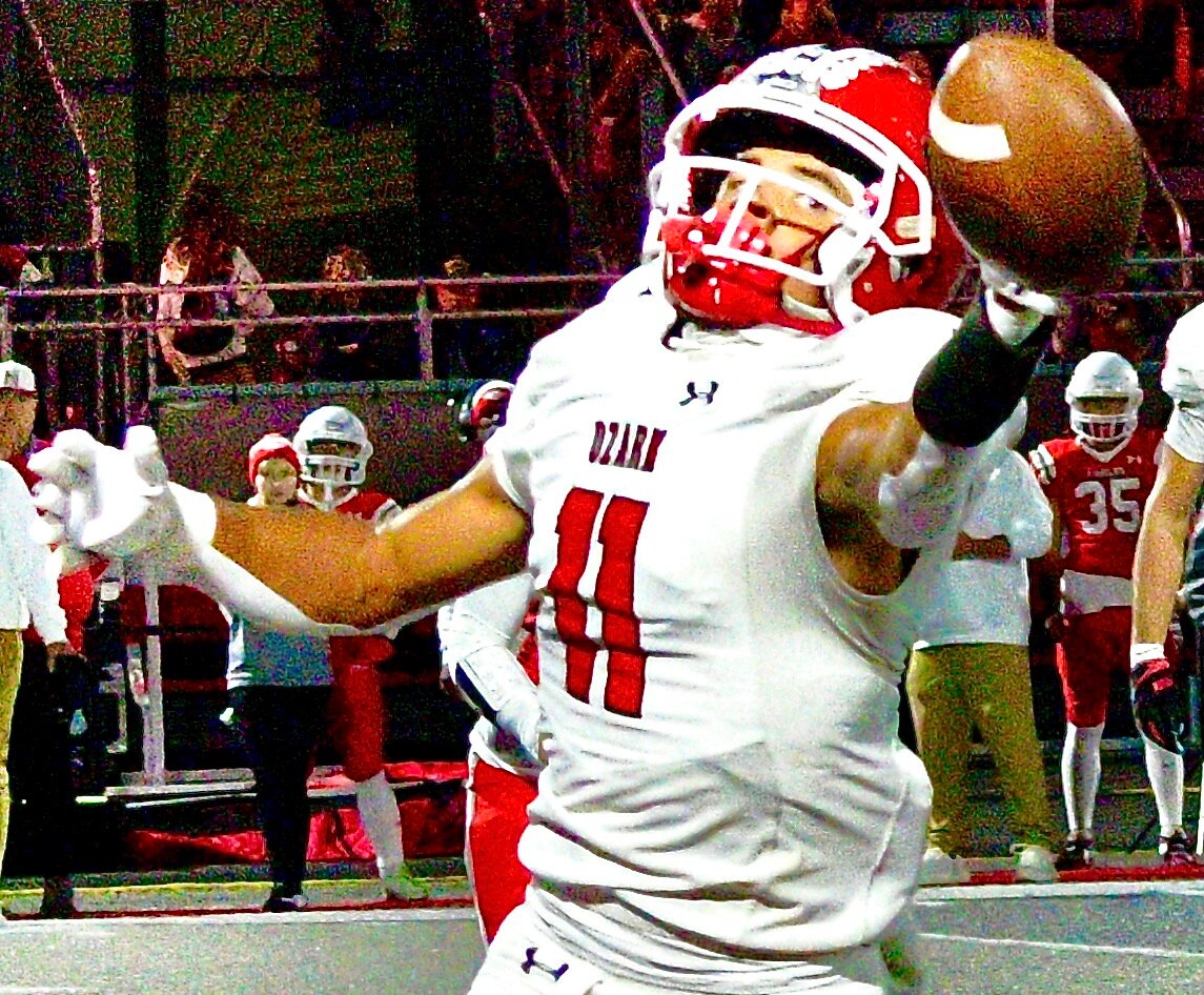 OZARK'S SAM CLARK reaches for a pass.