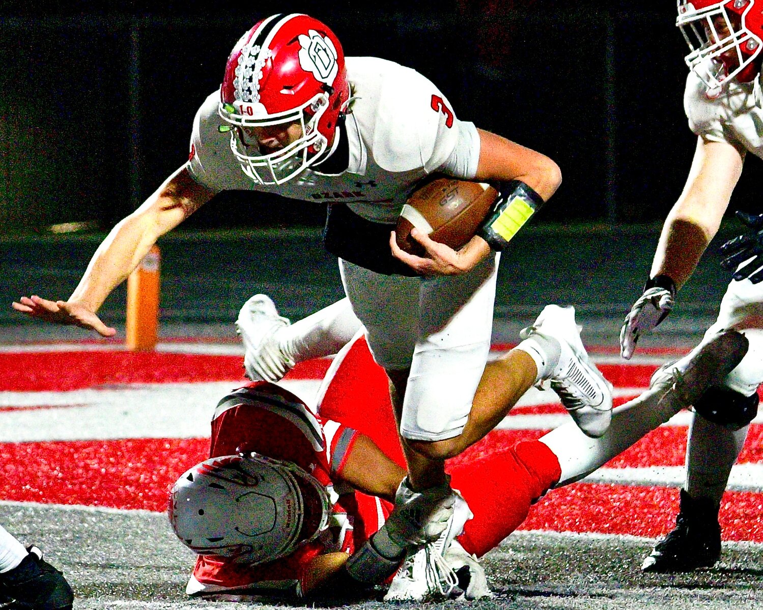 NIXA'S KADEN KELLEY tackles Ozark's Peyton Russell.