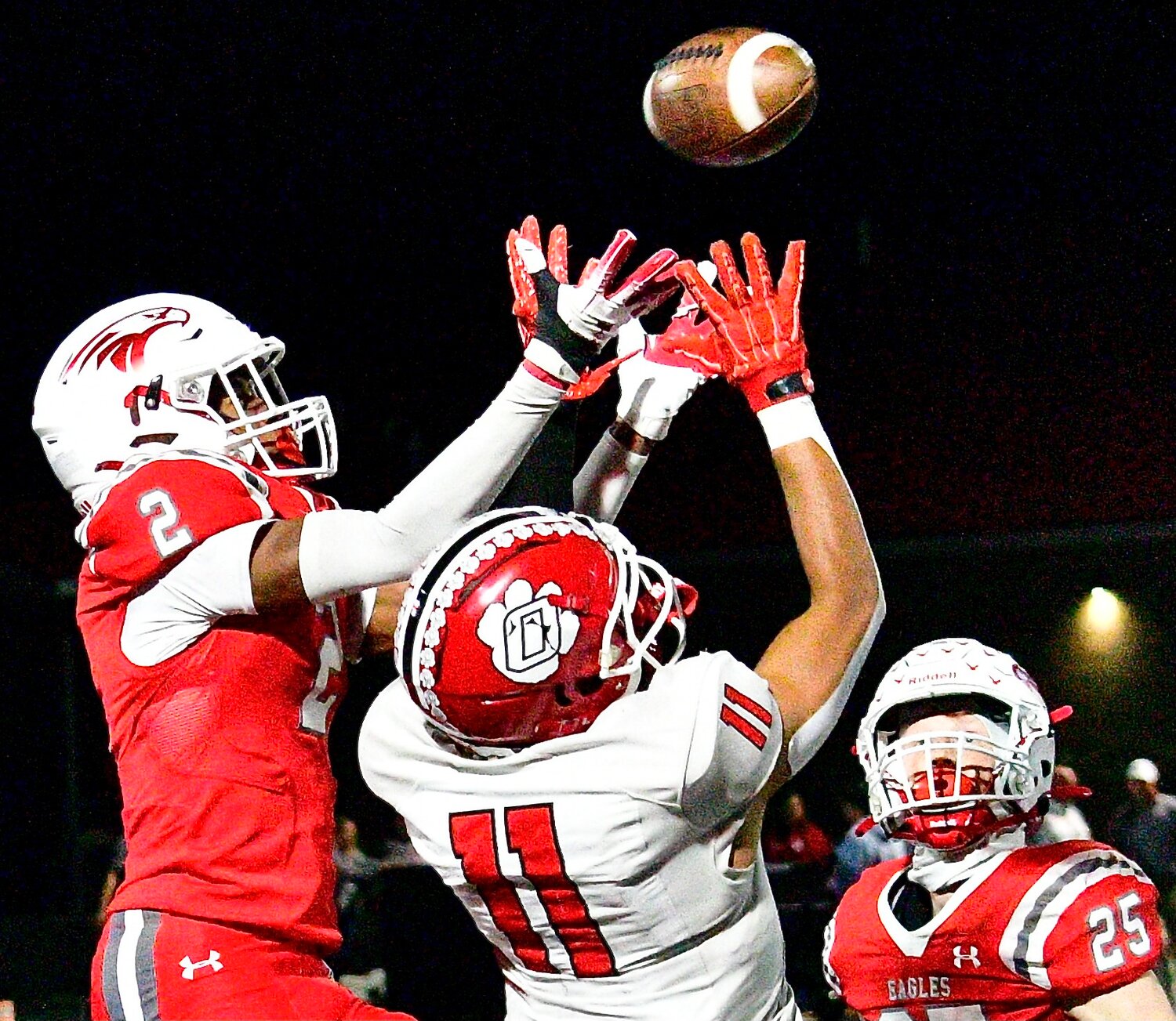 NIXA'S RANDY FLINT AND OZARK'S SAM CLARK battle for the ball Friday in the Backyard Brawl.