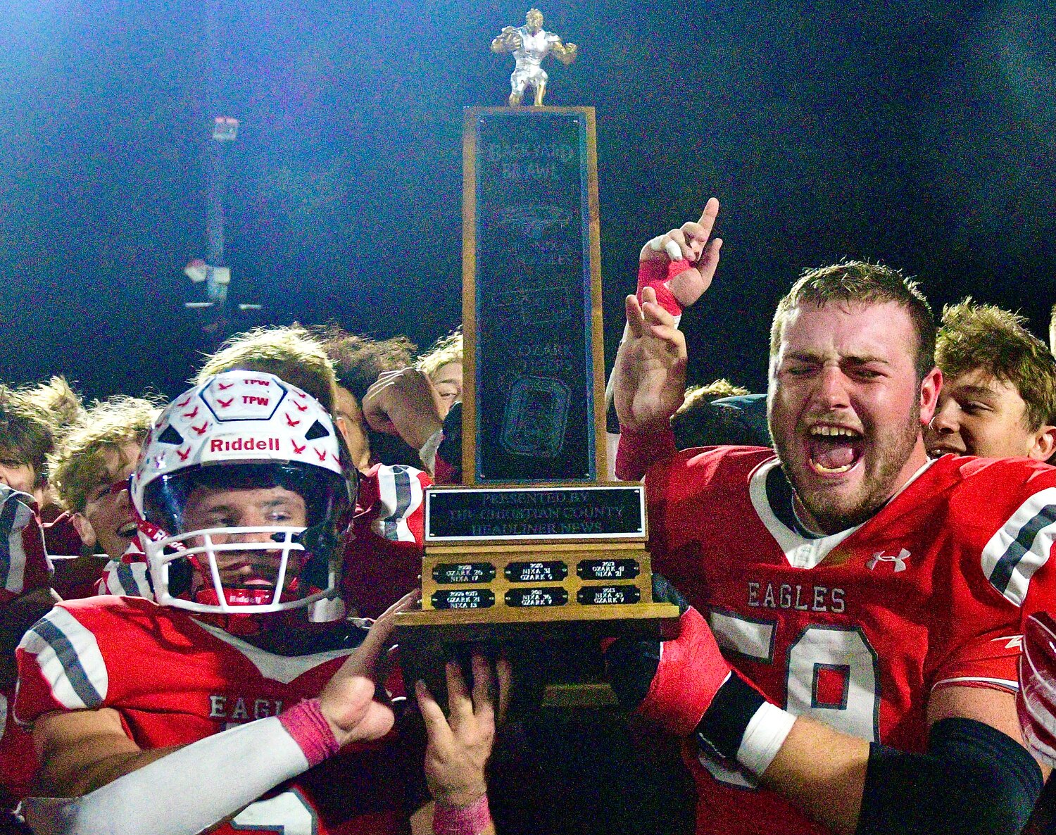 NIXA'S DYLAN REBURA AND JACOB LILE hold the Backyard Brawl trophy.