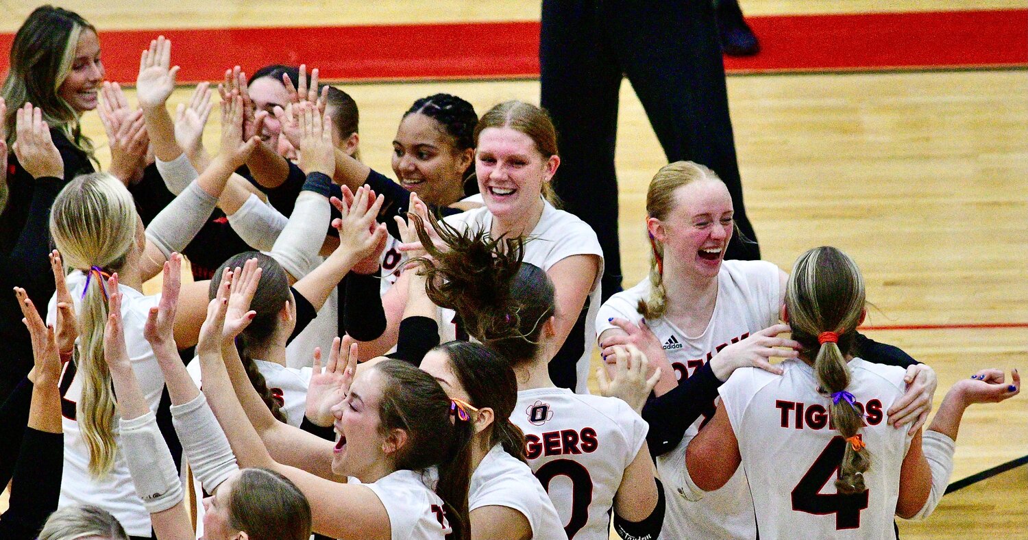 OZARK'S REECE COOK, TARA VENABLE AND SKYLAR HILTON lead the Lady Tigers' celebration following their Quarterfinal win Saturday.