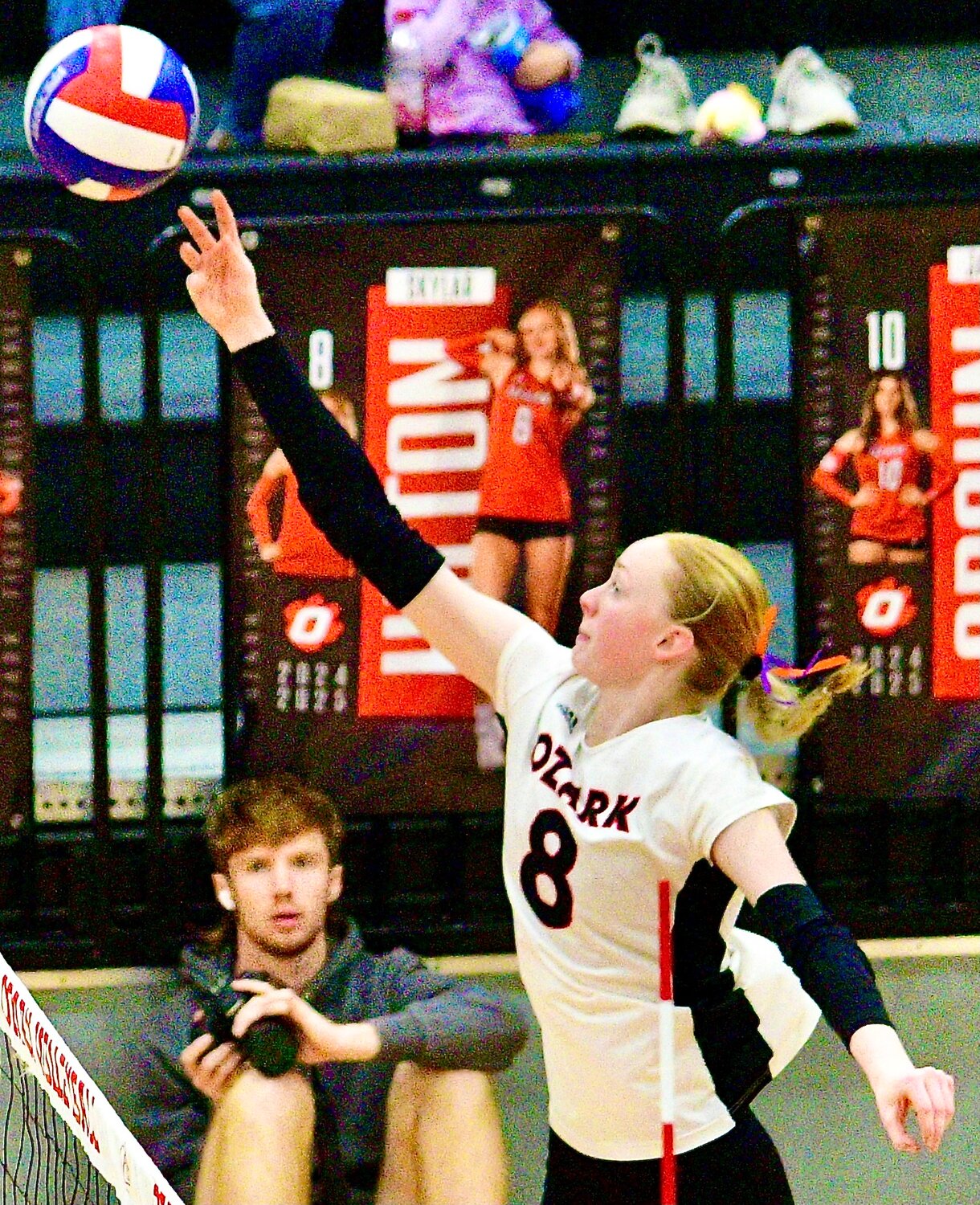 OZARK'S SKYLAR HILTON tips the ball over the net Saturday.