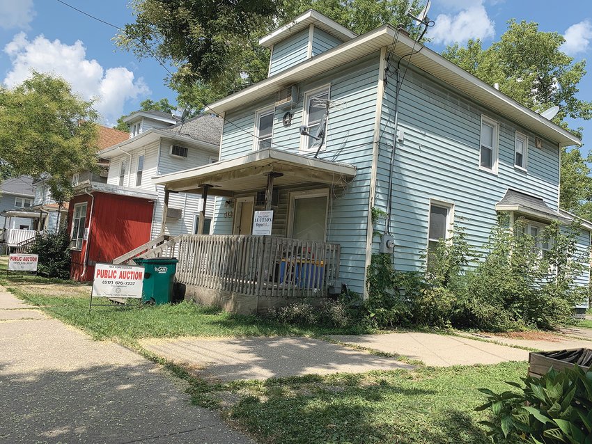 Below) Some bidding lots include two parcels, like these two homes along Oakland Avenue in Lansing. County officials expect those types of package deals will help accelerate meaningful development projects across Greater Lansing.