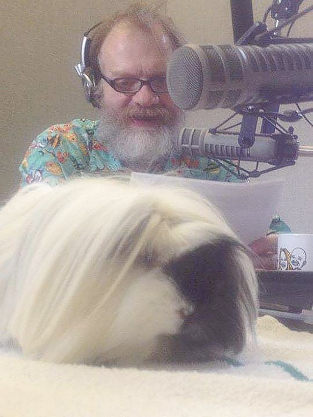 Rick Preuss poses with a guinea pig during his radio show on WILS.
