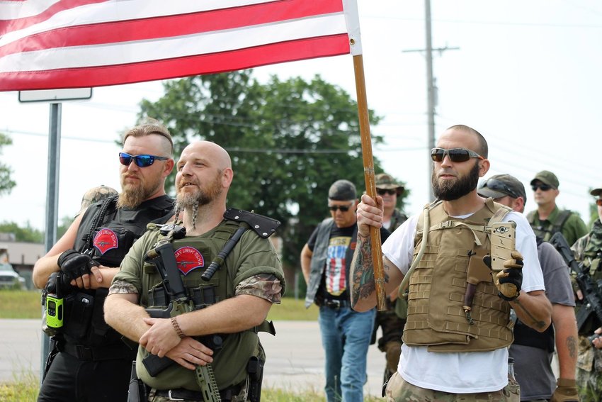 William Null (back left) stand with Phil Robinson, leader of the Michigan Liberty Militia during a June 10, 2017 anti-Sharia Law protest in south Lansing. 