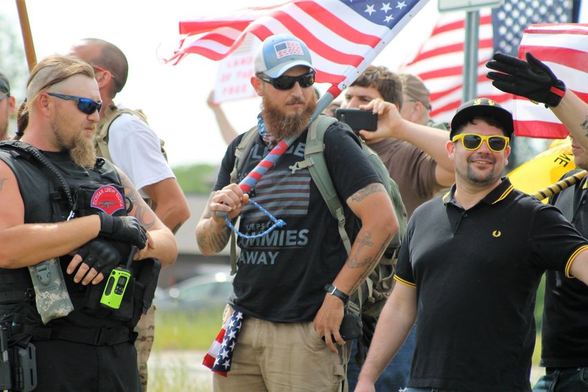 William Null, a member of the Michigan Liberty Militia and a defendant in a plot to kidnap Gov. Gretchen Whitmer (left) and an unidentified member of the Proud Boys (far right) at a June 10, 2017 protest against Sharia Law held in south Lansing. 