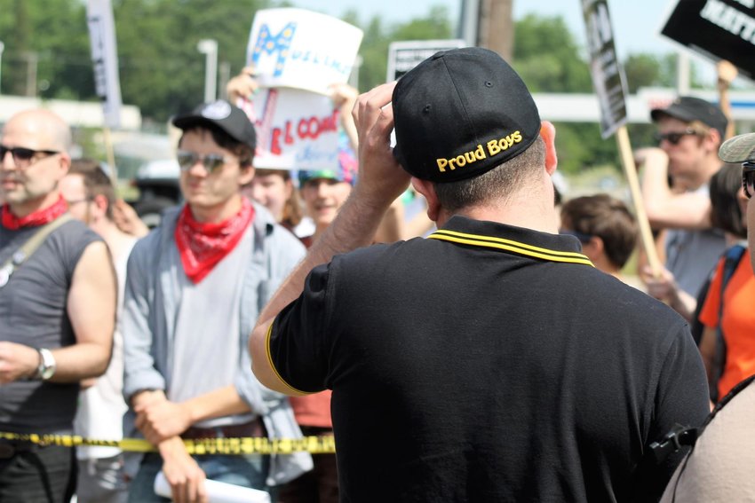 The back of second unidentified Proud Boy showing the group's trademark black and yellow polo as well as its hat with the name of the organization stitched into it. He was participating in an anti-Sharia Law protest on June 10, 2017 in south Lansing. 