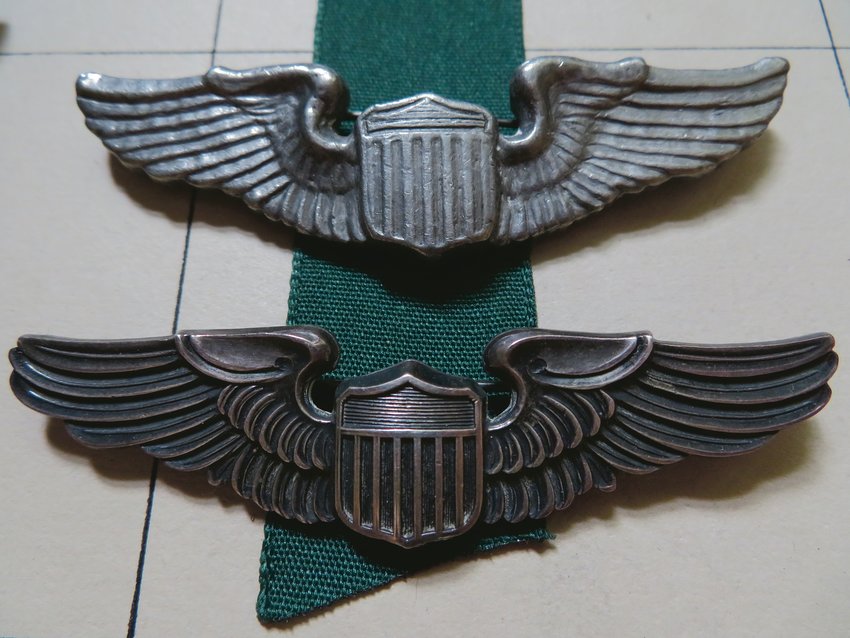 Hand-made airman's wings (above), made of molten foil cigarette and gum wrappers when Hilding was held prisoner at Stalag Luft III, look just like the real article, below. 