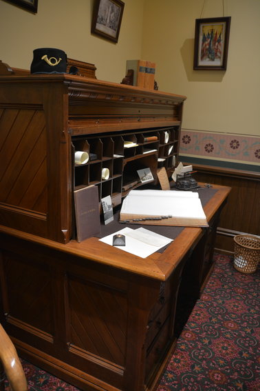 One of about two dozen desks purchased in 1878 and used in state offices for many years. Currently, the desk is used to display typical 19th-century office paraphernalia such as an ink well, a leather-bound ledger and a cabinet card featuring the Michigan Senate.