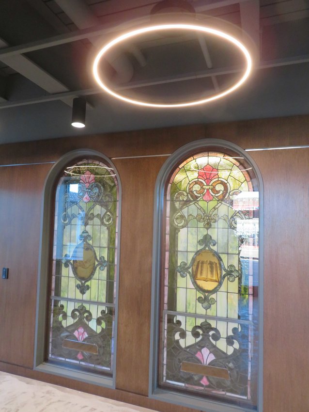 In the first floor office complex, old stained glass windows sport modern “halo” light fixtures.