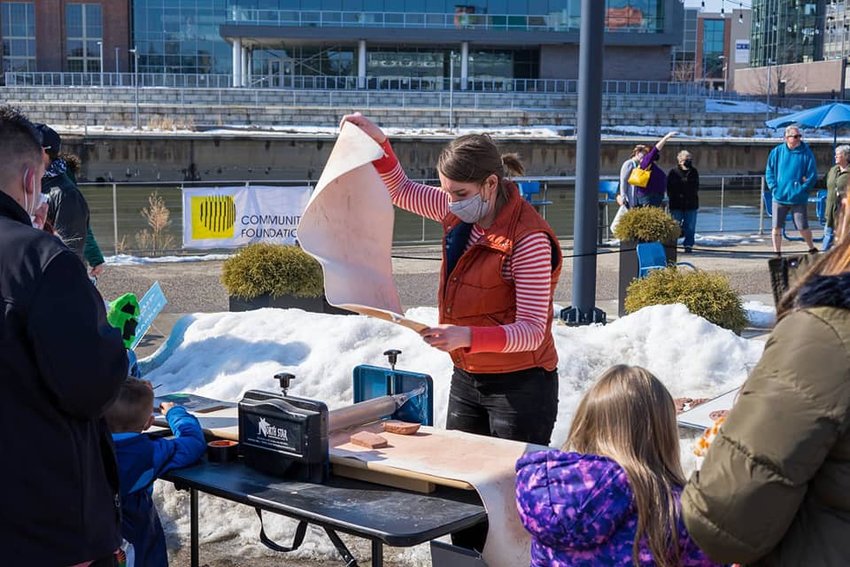 In 2021 and 2022, Alexandra Leonard used portable equipment to hold a series of socially distanced tile-making workshops all over town, like this one at the Winter Festival in February 2021.