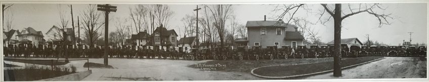 An army of milkmen, carts and horses from the Lansing Dairy in a panorama taken in 1922 in the middle of Cedar Street, near the 500 block, just north of Shiawassee Street.