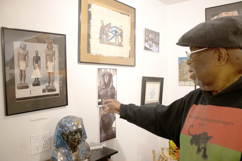 Willie Davis with various photos of his Egyptian travel at the African World Museum and Resource Center. Photo: Taylor Blair for City Pulse