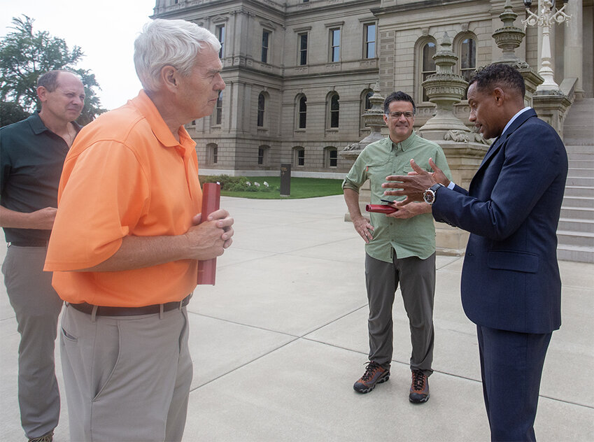 Harper talks to three visiting Ohioans in front of the Michigan Capitol. One of them lectured him on the importance of fundraising — not Harper’s favorite topic.