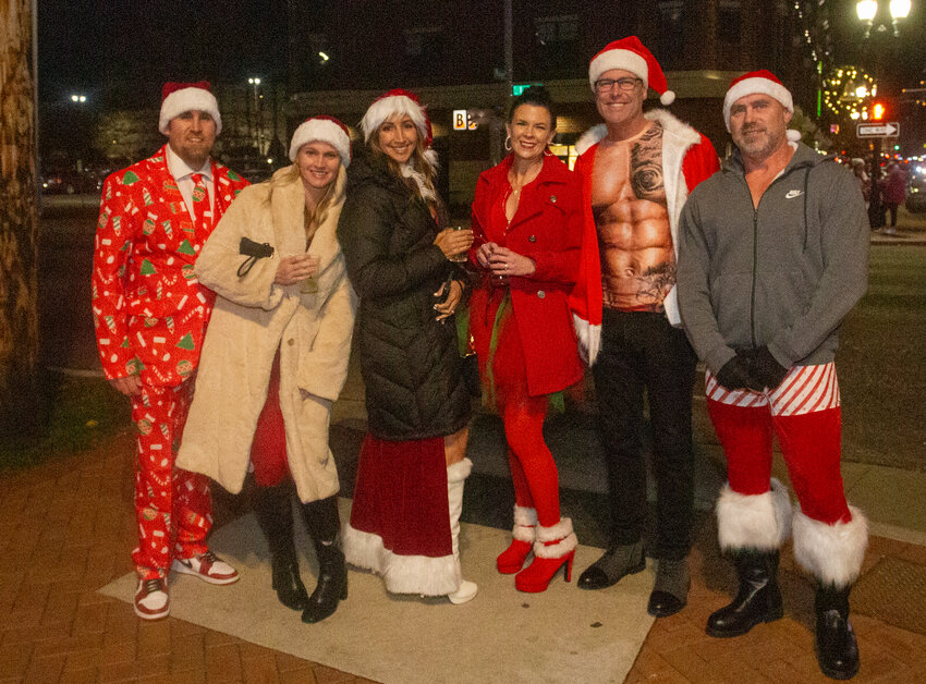 A group dressed in Christmas pajamas prepares to head out to a post-Silver Bells party or bar crawl.