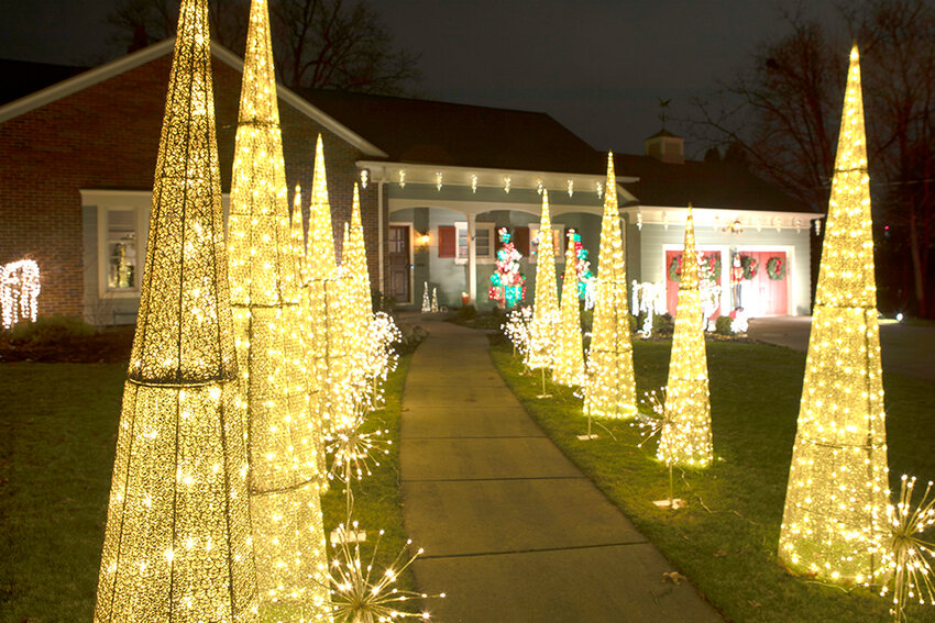 Raymond Holt for City Pulse
Holiday lights shine a path to the front door of this home on Moores River Drive in Lansing.