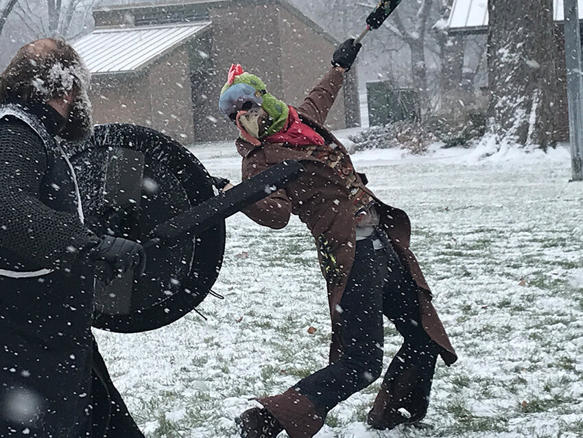 A masked Ashen Hills player strikes during a midwinter game.