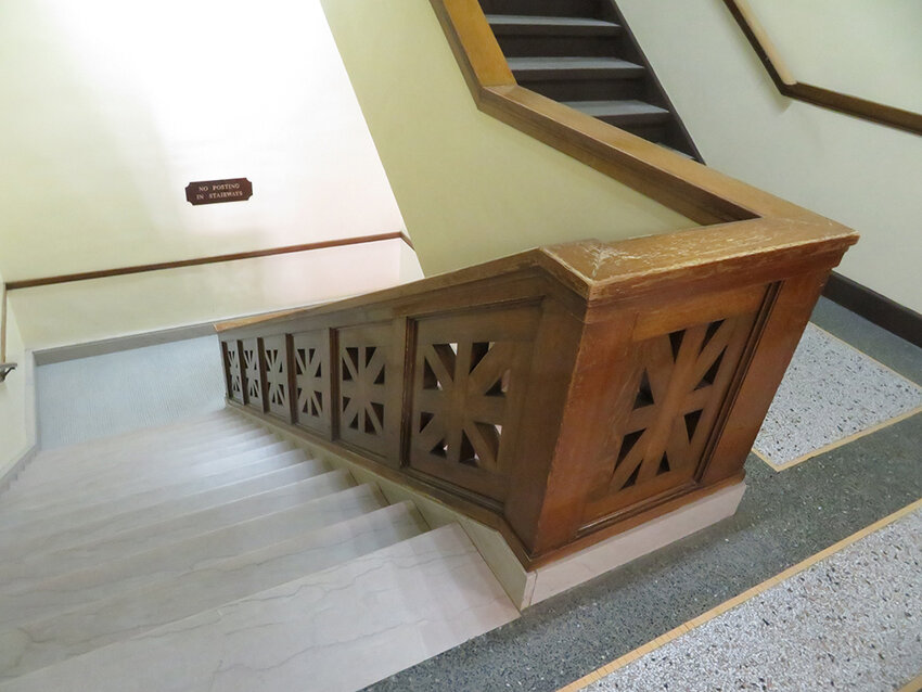 The stairs offer original woodwork and terrazzo floors.