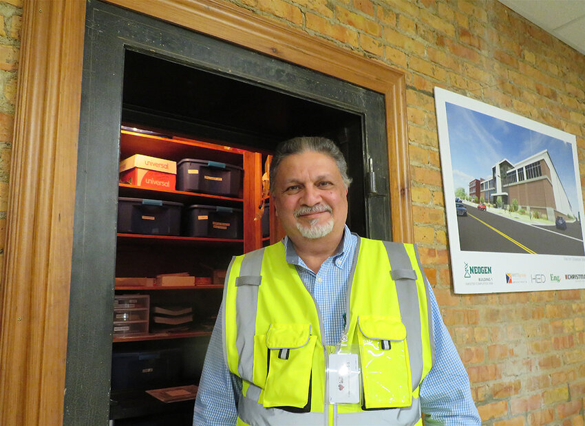 Hasan Yamani, senior director of capital projects for the Neogen Corp., shows off the old documents vault of the Herbert Annex, a wood-framed former tractor factory and furniture warehouse at 728 E. Shiawassee St., one of several century-old buildings in Lansing adapted by Neogen for labs, offices and manufacturing.  