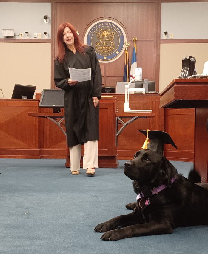 Ingham County Circuit Chief Judge Joyce Draganchuk swears in Basil as the court's victim support dog at a ceremony today.
