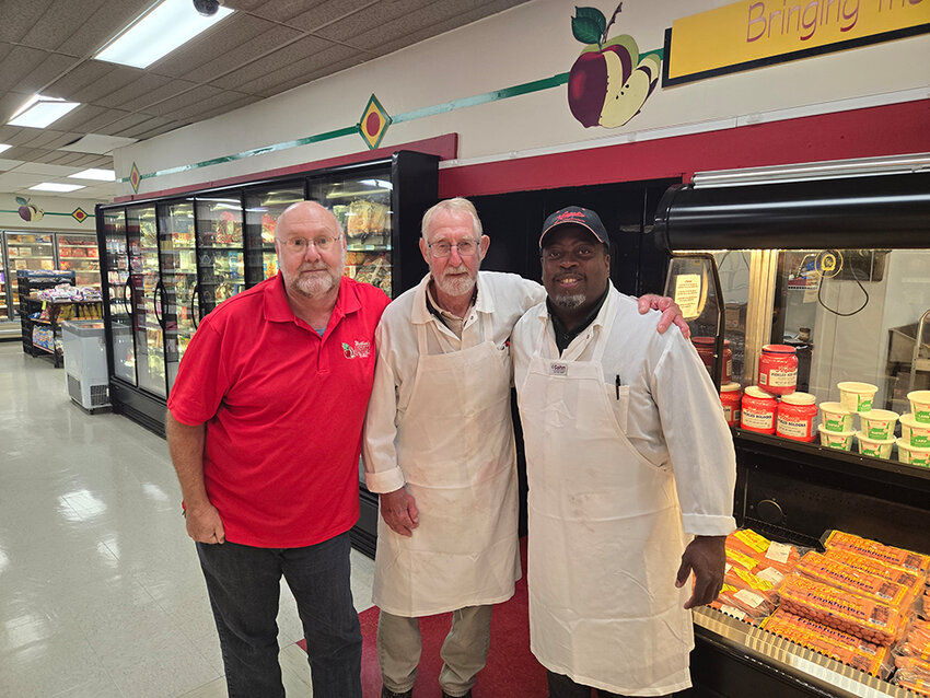 From left: Tim Westlund, owner of Westlund’s Apple Market, poses with two of the store’s butchers, Phil Bahle and Alan Jackson.