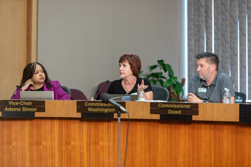 (From left) Lansing Charter Commissioners Lori Adams Simon, Jody Washington and Ben Dowd listen in on a discussion during the body's July 2 regular meeting.