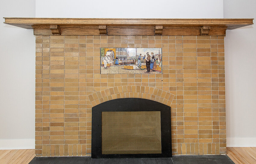 Among the interior features in the old Holmes Street School is a brick fireplace with a tile mural.