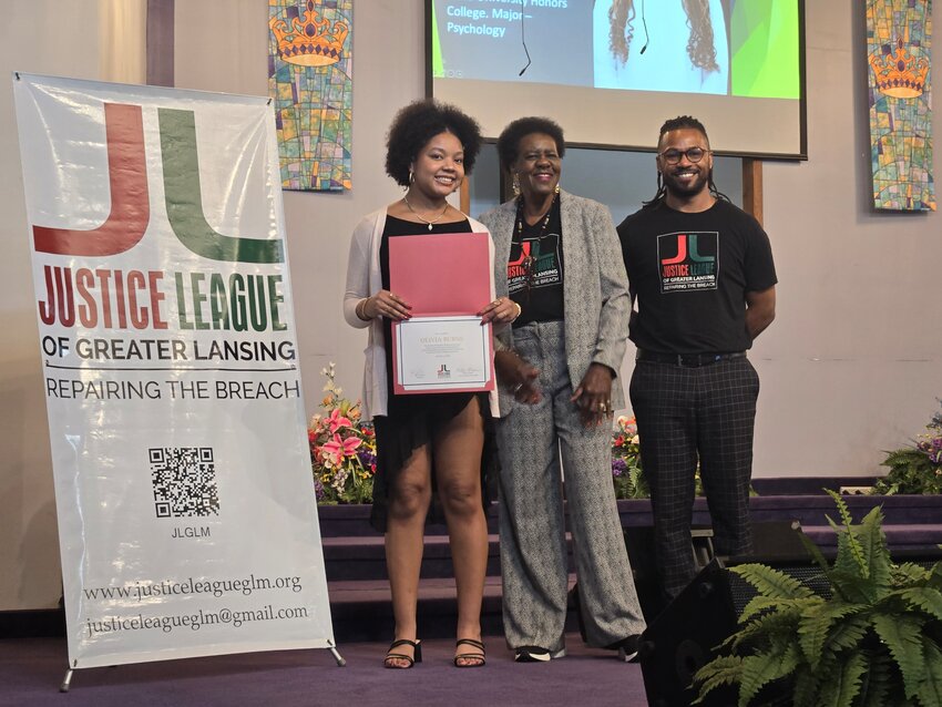 (From left) Recent East Lansing High School graduate Olivia Burns accepts a scholarship from Justice League of Greater Lansing founder Willye Bryan and Price Solace in a ceremony last Saturday.