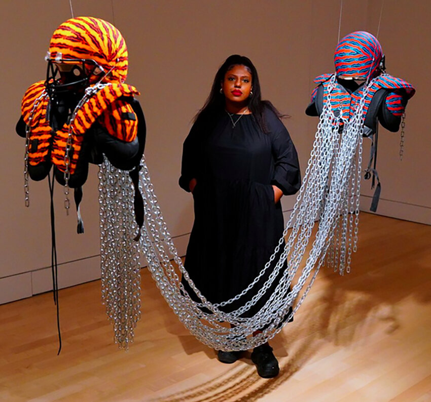 Esmaa Mohamoud poses with one of her pieces showcased in “Resistance Training,” a fall 2023 exhibit at the Broad.