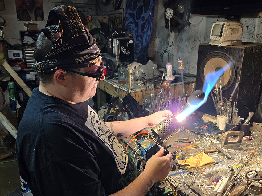 With a blowtorch and a piece of glass, Vicknair begins the process of crafting an artisan ashtray.