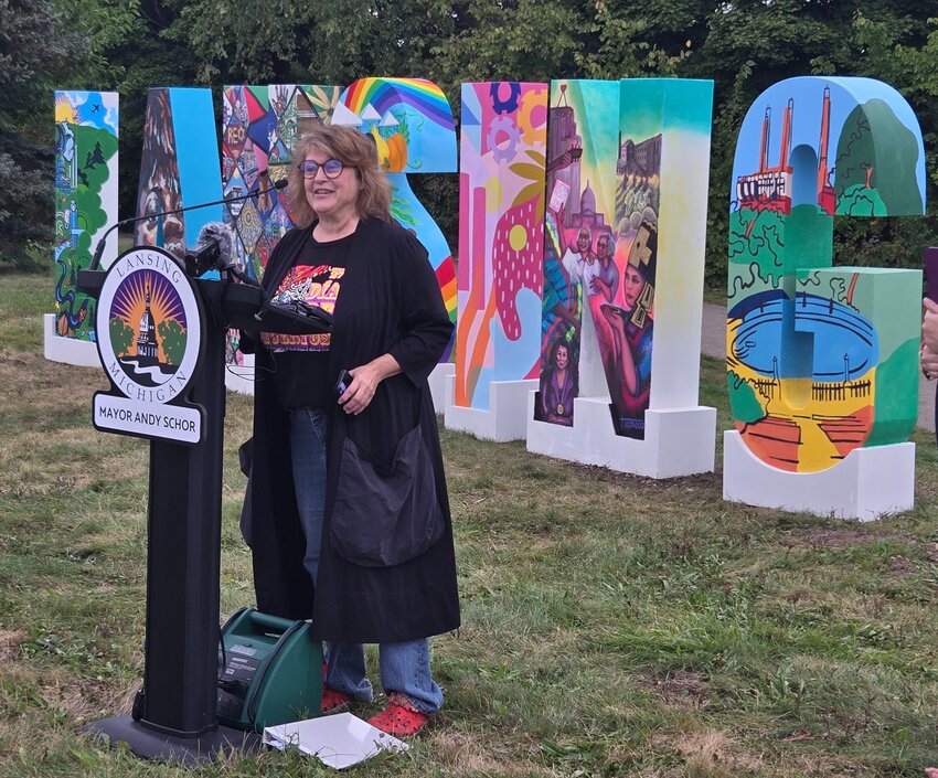 Theresa Rosado discusses her work on the second "N" of the new Lansing sign.