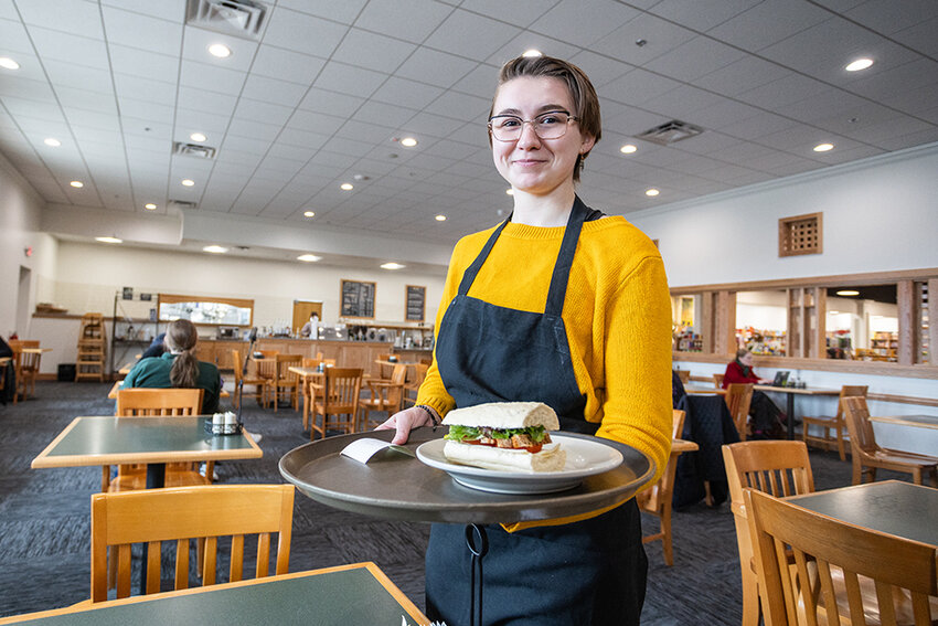 Photo by Raymond Holt
The Chapbook Cafe is a popular stop for Schuler patrons. Server Sovereign Schoenherr brings a sandwich to an eagerly waiting photographer.